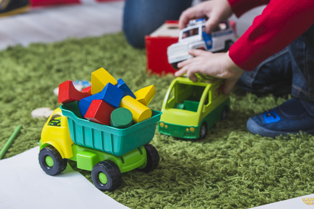 kid-playing-with-toy-cars_23-2147797995